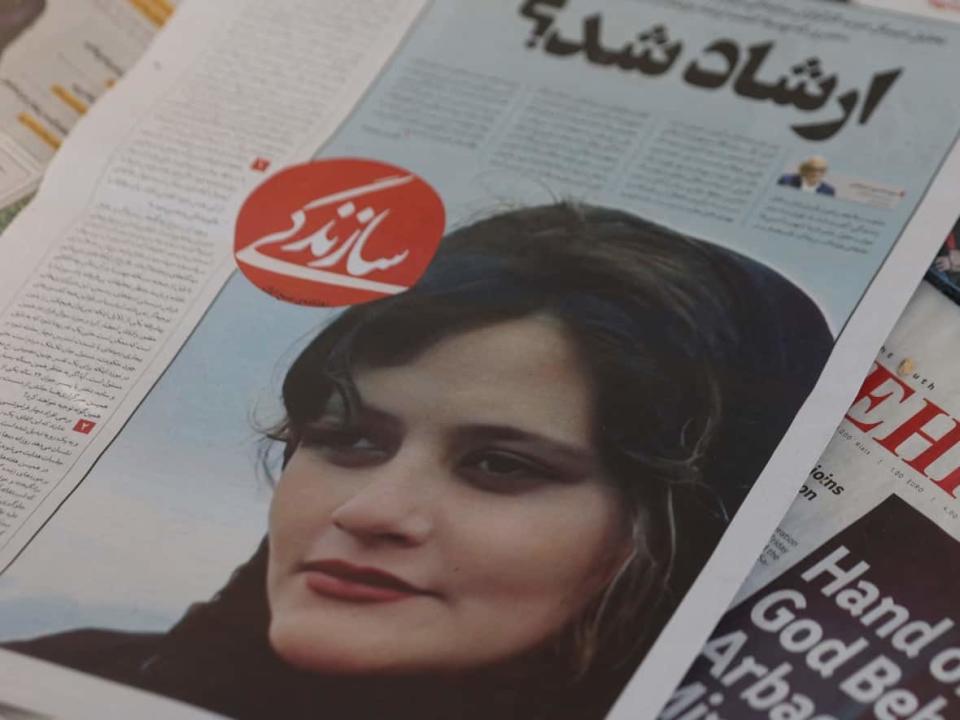 A newspaper with a cover picture of Mahsa Amini, a woman who died after being arrested by the Islamic republic's 