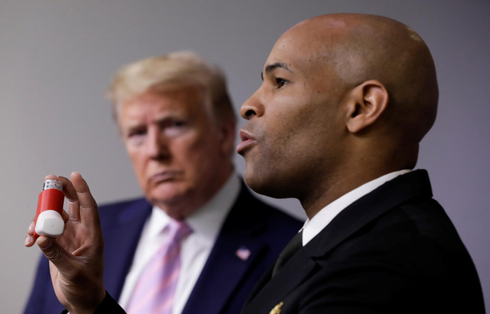 U.S. Surgeon General Jerome Adams holds up his own personal asthma inhaler as President Donald Trump watches and listens to Adams discuss the effect of pre-existing conditions in the U.S. African-American community during the coronavirus response daily briefing at the White House in Washington, U.S., April 10, 2020. REUTERS/Yuri Gripas