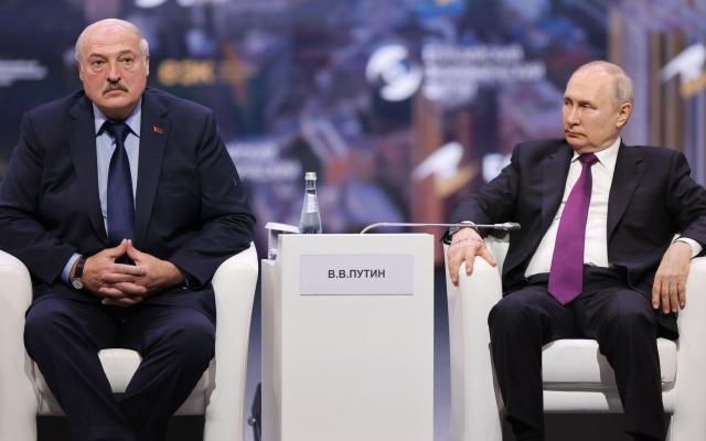 Belarusian President Alexander Lukashenko (L) and Russian President Vladimir Putin attend a plenary session of the 2nd Eurasian Economic Forum in Moscow on 24 May - ROSCONGRESS PRESS-SERVICE/HANDOUT/EPA-EFE/Shutterstock/Shutterstock
