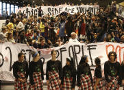 People gather to take part in the ecological organizations demonstration during the COP24 summit at the 'Spodek' multipurpose arena complex in Katowice, Poland, Friday, Dec. 14, 2018. (AP Photo/Czarek Sokolowski)