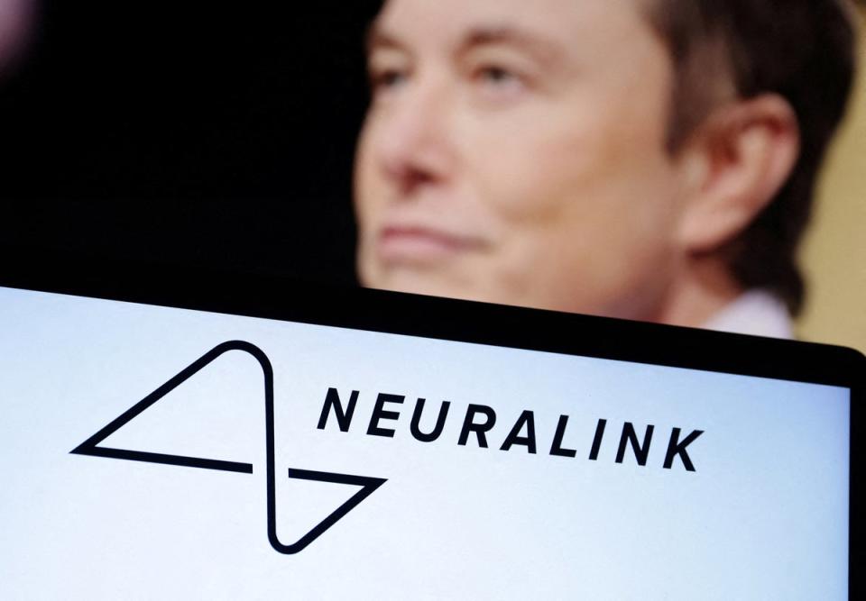 Elon Musk, and the Neuralink logo, pictured in 2022. A former Neuralink employee is suing the company, claiming she was fired after she told her superiors she was pregnant (REUTERS)