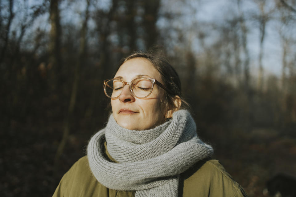 Woman walking in the winter sunshine. (Getty Images)