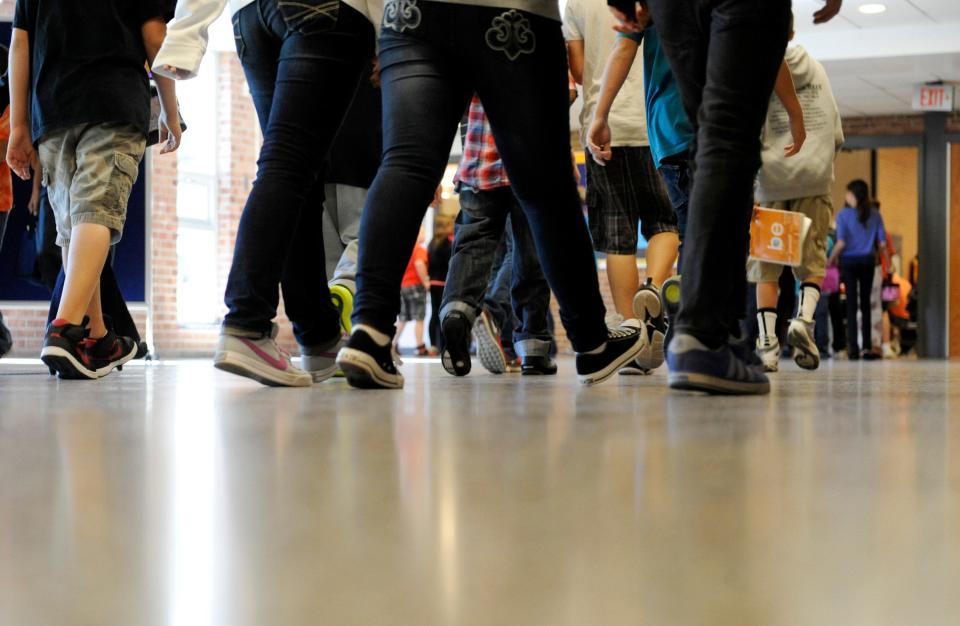 Students walk in a school hallway in September 2012.