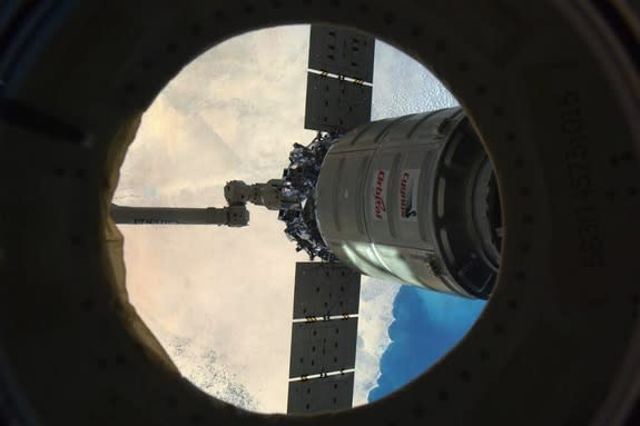 Through a porthole in the International Space Station, NASA astronaut Rick Mastracchio caught this view of Orbital Sciences Corp.'s Cygnus cargo spacecraft departing Feb. 18, over the Middle East.