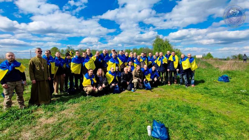 Ukrainian prisoners of war (POWs) pose for a picture after a swap at an unknown location in Ukraine