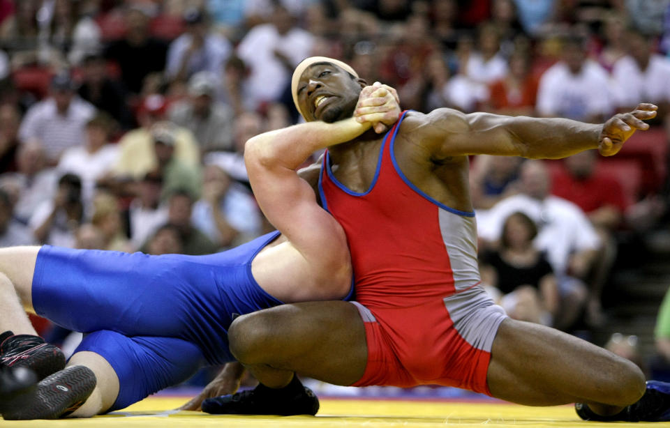 T.C. Dantzler (red) endures a choke hold by Cheney Haight (blue) in the Greco-Roman 74kg division championship match during the USA Olympic trials for wrestling and judo on June 14, 2008 at the Thomas & Mack Center in Las Vegas, Neveda. (Jonathan Ferrey/Getty Images)