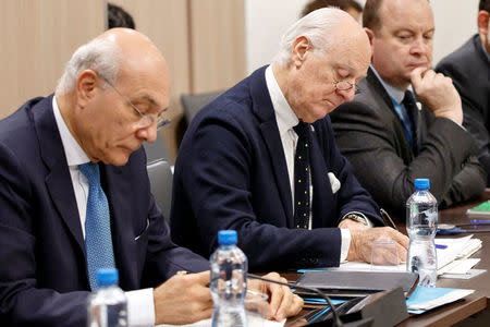 UN Special Envoy to the Secretary-General for Syria Staffan de Mistura and UN Deputy Special Envoy for Syria Ramzy Ezzeldin Ramzy, left, attend a round of negotiation with Nasr al-Hariri (not pictured), Head of the Syrian Negotiation Commission, during the Intra Syria talks at the European headquarters of the United Nations in Geneva, Switzerland December 13, 2017. REUTERS/Salvatore Di Nolfi/Pool