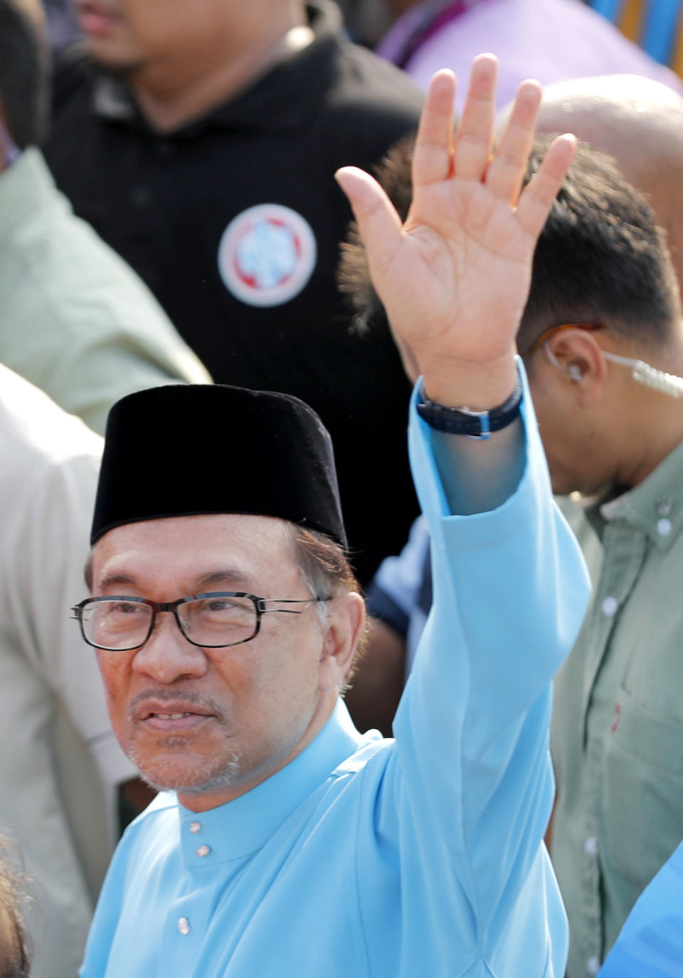 Malaysia's reform icon Anwar Ibrahim waves to his supporters as he arrives for by-election nomination in Port Dickson, Malaysia, Saturday, Sept. 29, 2018. Anwar is contesting by-election in Port Dickson, a southern coastal town after a lawmaker vacated the seat to make way for Anwar Ibrahim's political comeback. (AP Photo/Vincent Thian)