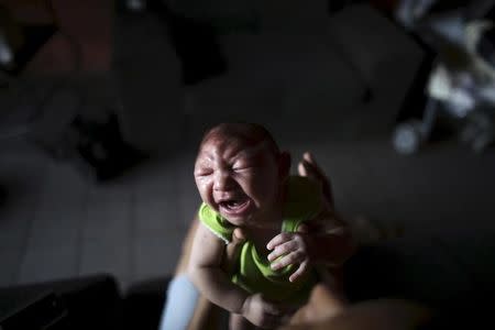 Daniele Santos, 29, holds her son Juan Pedro who is 2-months old and born with microcephaly, at their house in Recife, Brazil, February 9, 2016. REUTERS/Nacho Doce