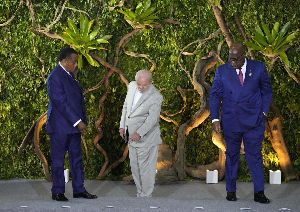 Brazil's President Luiz Inacio Lula Da Silva, center, Democratic Republic of Congo President Felix Tshisekedi, right, and Congo President Denis Sassou Nguesso find their spots for a group photo during the Amazon Summit at the Hangar Convention Center in Belem, Brazil, Wednesday, Aug. 9, 2023. The Amazon Summit nations from South America welcomed representatives from rainforest nations in Africa and Southeast Asia, as well as interested European parties. (AP Photo/Eraldo Peres)