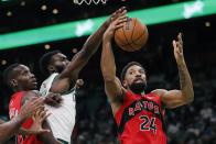 Toronto Raptors' Khem Birch (24) grabs a rebound against Boston Celtics' Jayson Tatum, second from left, during the second half of an NBA basketball game, Friday, Oct. 22, 2021, in Boston. (AP Photo/Michael Dwyer)