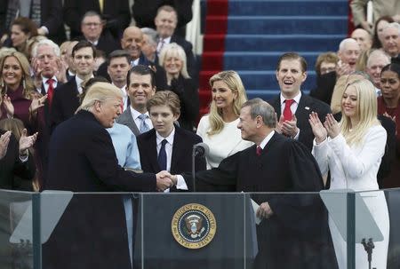 President Donald Trump shakes hands with Justice John Roberts (R) after taking the oath at inauguration ceremonies swearing in Trump as the 45th president of the United States on the West front of the U.S. Capitol in Washington, U.S., January 20, 2017. REUTERS/Carlos Barria