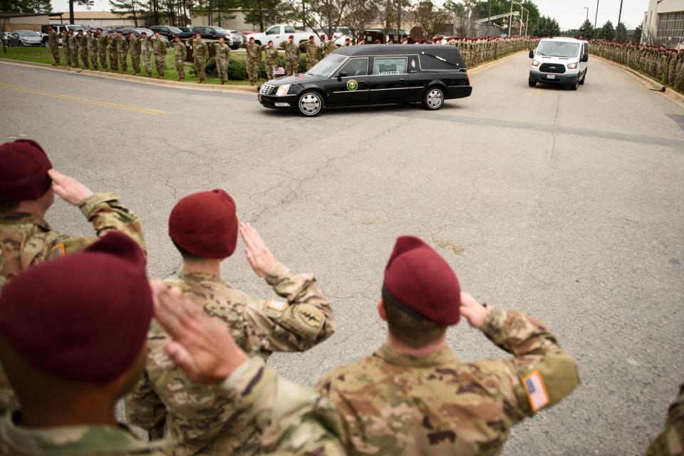 Soldiers salute as a hearse carrying the remains of Staff Sgt. Ian Paul McLaughlin drive by on Fort Bragg, N.C., on Saturday, Jan. 18, 2020. McLaughlin was killed Jan. 11 in Afghanistan.