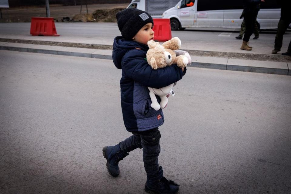 A young child holds tightly to his teddy bear after crossing the border with his mother in Medyka Poland on March 5, 2022.