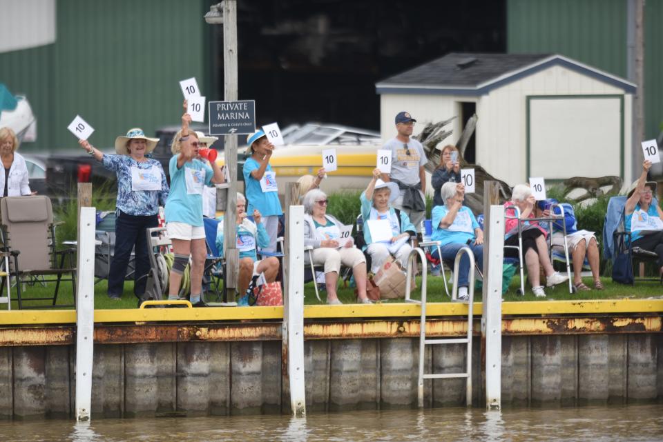 Spectators cheer as sailboats exit the Black River to the start of the Port Huron-to-Mackinac Island Sailboat Race on Saturday, July 15, 2023.