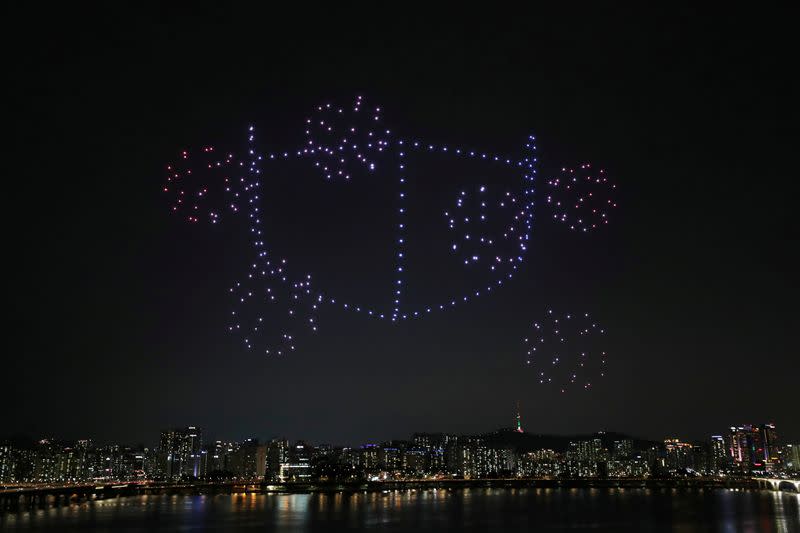 Drones fly over the Han river showing messages to support the country as measures to avoid the spread of the coronavirus disease (COVID-19) continue in Seoul