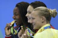 2016 Rio Olympics - Swimming - Victory Ceremony - Women's 100m Freestyle Victory Ceremony - Olympic Aquatics Stadium - Rio de Janeiro, Brazil - 11/08/2016. Joint gold medallists Simone Manuel (USA) of USA and Penelope Oleksiak (CAN) of Canada and bronze medallist Sarah Sjostrom (SWE) of Sweden pose with their medals. REUTERS/Marcos Brindicci