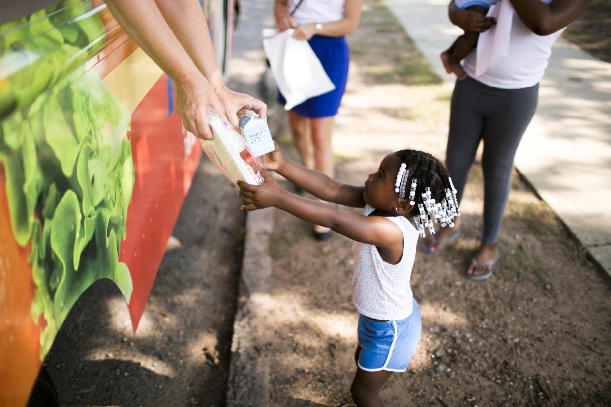 A child in Greater New Haven receives summer meals distributed by food truck. (Courtesy Share our Strength)