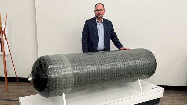 Charles Shappell, engineering director for Faurecia Hydrogen Solutions, displays two of the company’s hydrogen tanks. (Photo: Alan Adler/FreightWaves)