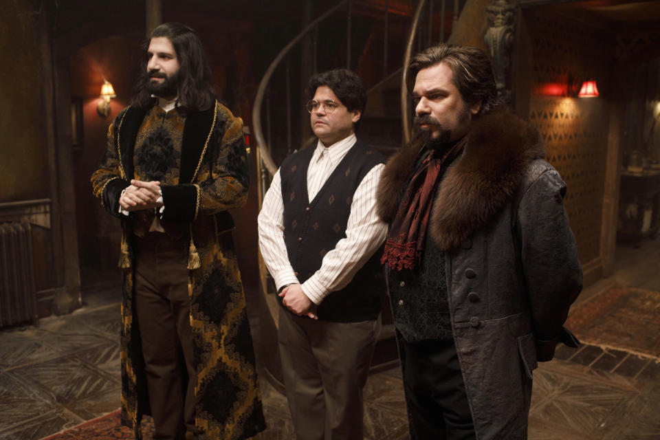 This image released by FX shows Kayvan Novak, form left, Harvey Guillen and Matt Berry in a scene from "What We Do In the Shadows." The series premiering Wednesday is based on the 2014 cult-hit movie from New Zealand. (John P Johnson/FX via AP)