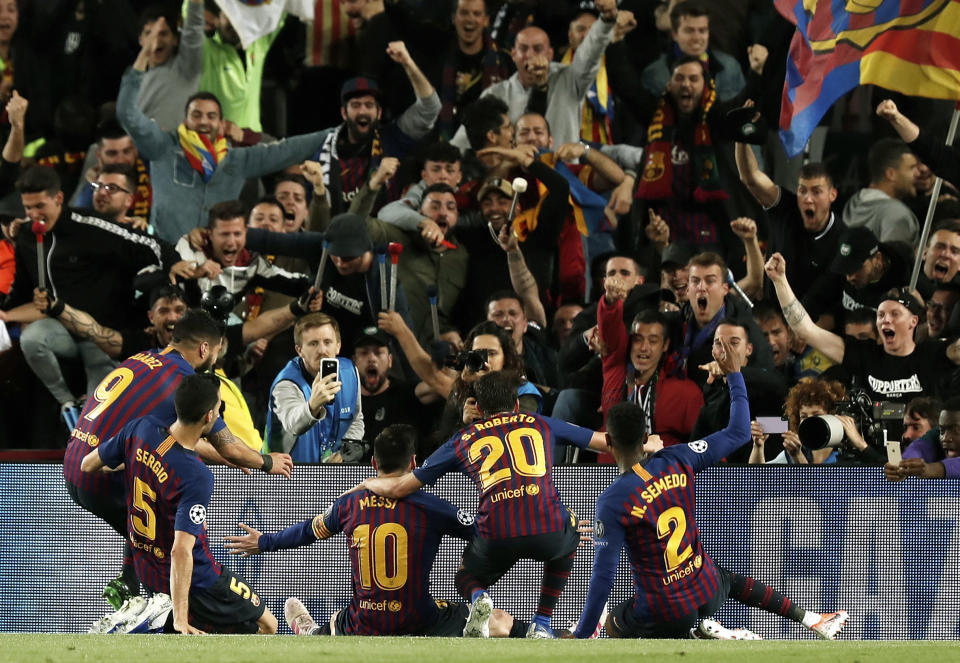 Barcelona's Lionel Messi, center, celebrates after scoring his side's third goal during the Champions League semifinal, first leg, soccer match between FC Barcelona and Liverpool at the Camp Nou stadium in Barcelona Spain, Wednesday, May 1, 2019. (AP Photo/Joan Monfort)
