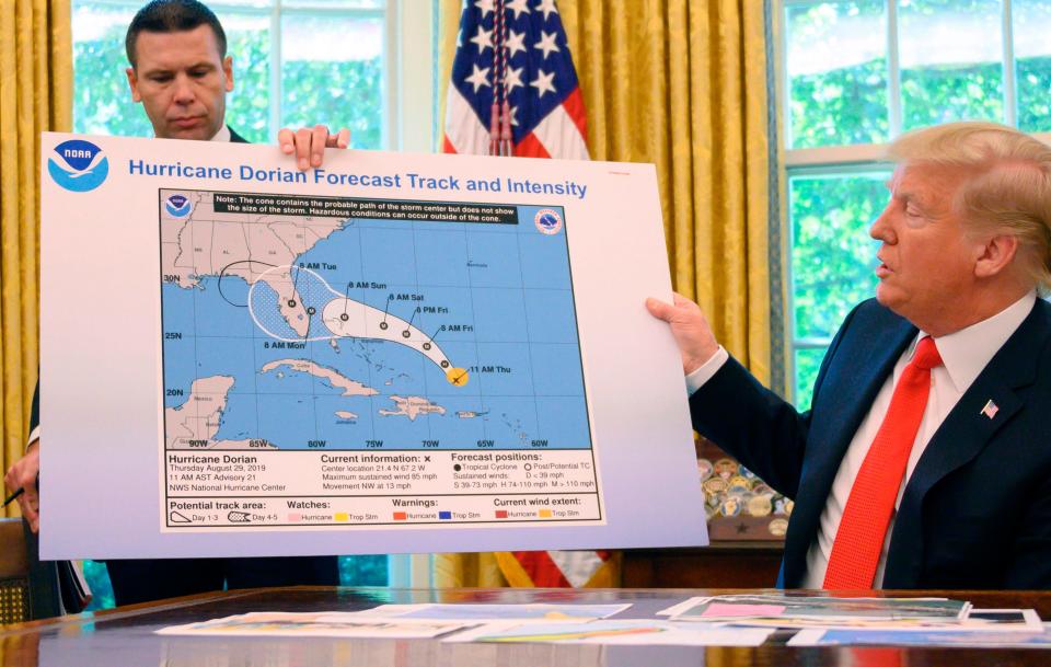 In this file photo taken on September 4, 2019, US President Donald Trump and Acting US Secretary of Homeland Security Kevin McAleenan update the media on Hurricane Dorian preparedness from the Oval Office at the White House in Washington, DC.