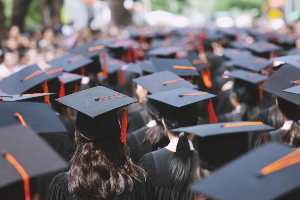 Graduates in caps and gowns at a commencement ceremony, symbolizing an important family milestone