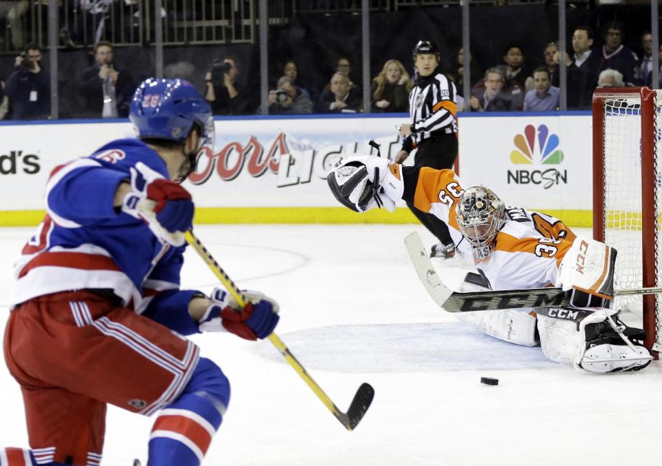 Philadelphia Flyers goalie Steve Mason (35) stops a shot on goal by New York Rangers' Martin St. Louis (26) during the second period in Game 7 of an NHL hockey first-round playoff series on Wednesday, April 30, 2014, in New York. (AP Photo)