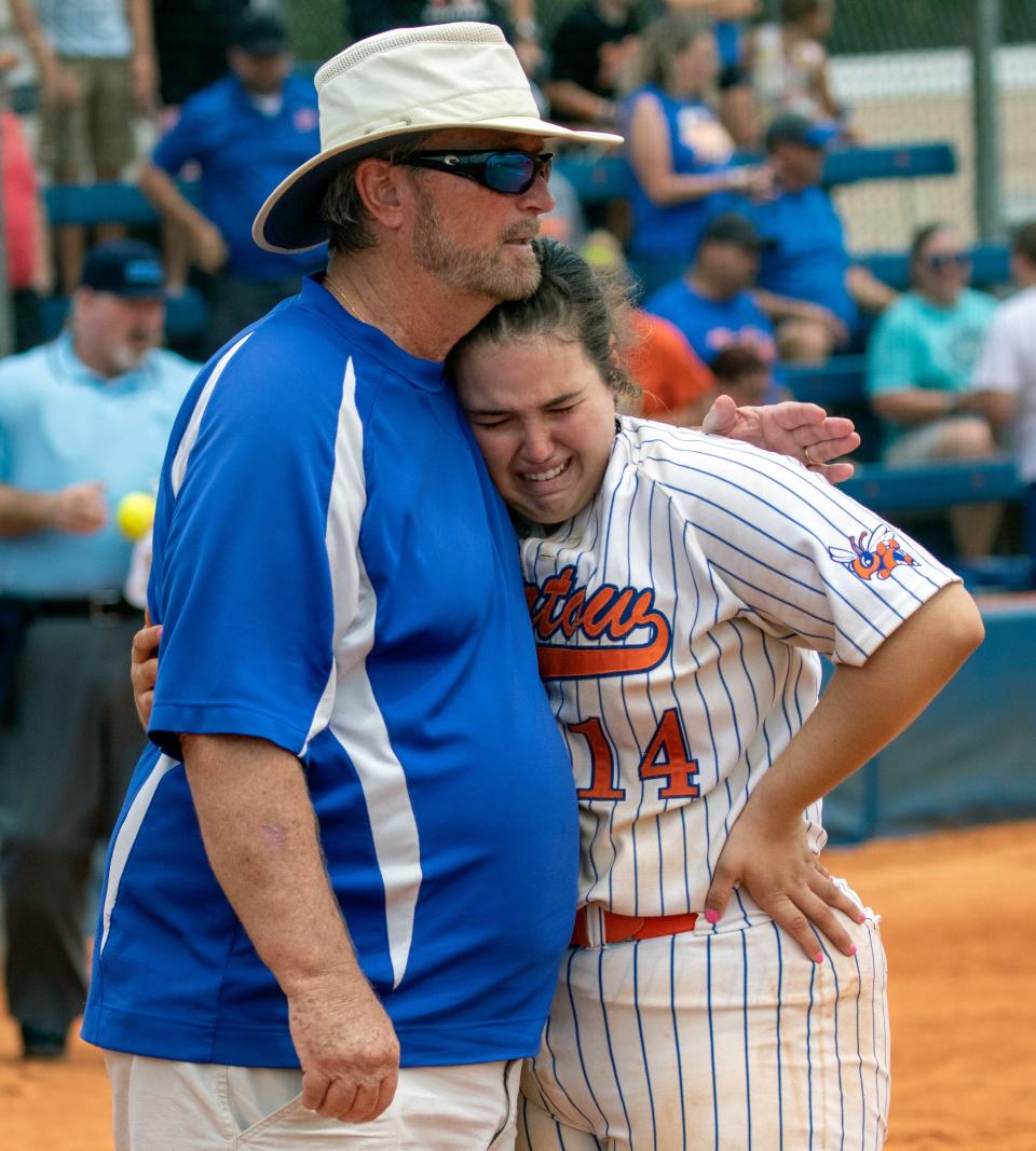 Bartow assistant coach Carl Howell consoles first baseman Morgan Grubb following Bartow's 2-0 loss to Melbourne on Saturday in the Class 6A, Region 3 final.