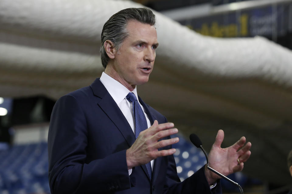 FILE — In this Monday April 6, 2020 file photo, Gov. Gavin Newsom discusses the acquisition of the Sleep Train Arena for use as a field hospital, after touring the facility, in Sacramento, Calif., Newsom announced, Tuesday, April 7, 2020 the state will spend nearly $1 billion to purchase up to 200 million masks per month to boost the state's stockpile of protective equipment during the COVID-19 outbreak and provide as a supplier to other western states. (AP Photo/ (AP Photo/Rich Pedroncelli, Pool, File)