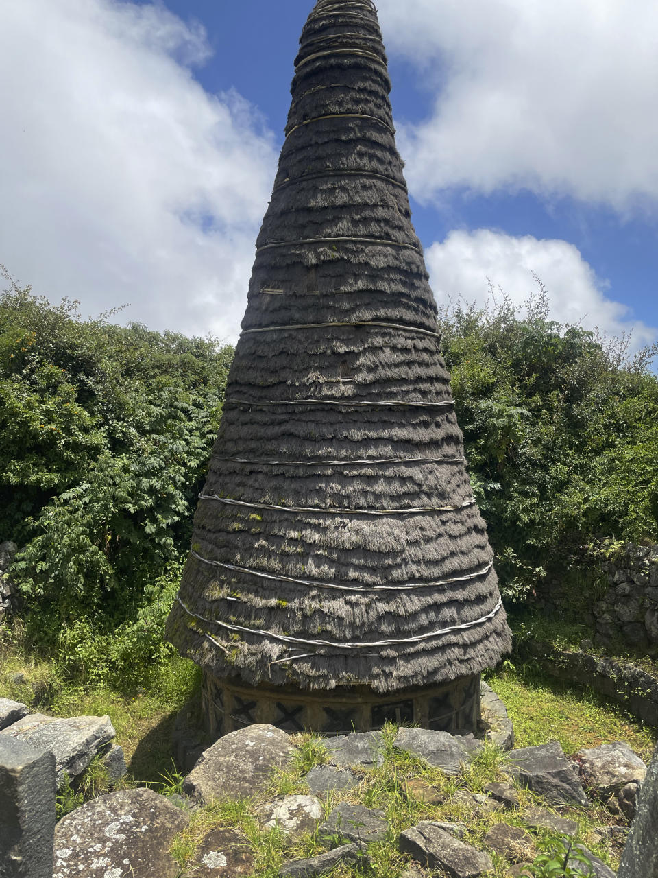 A conical temple dedicated to the deity Moonbu, constructed by members of the Toda tribe in the Nilgiris Hills of southern India with stone, cane and a special type of grass from the sacred grasslands, on Aug. 31, 2023. This temple is located in the heart of a sacred grassland and Toda settlement known as Muttunad Mund. (AP Photo/Deepa Bharath)