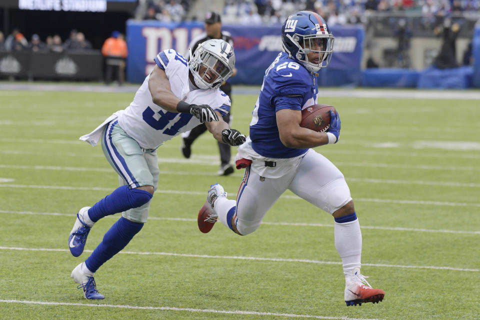 Dallas Cowboys' Byron Jones, left, tries to catch New York Giants' Saquon Barkley during the first half of an NFL football game, Sunday, Dec. 30, 2018, in East Rutherford, N.J. (AP Photo/Bill Kostroun)