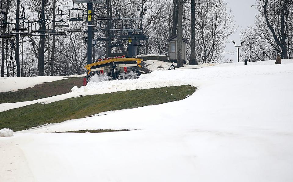 Snow Trails employees work Thursday to get the slopes in condition for their opening on Friday.
