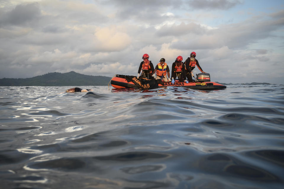 Rescuers recover the body of a Rohingya refugee from the waters off Meulaboh, Indonesia, on Saturday, March 23, 2024. The bodies of 12 women and three children were recovered following the capsize of a boat that was carrying around 140 Rohingya refugees, according to the United Nations High Commissioner for Refugees. Sixty-seven people were killed in the disaster. (AP Photo/Reza Saifullah)