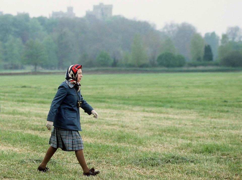 The Queen In Laced Up Brogue Shoes And Raincoat Walking In Windsor Great Park In The Grounds Of Windsor Castle