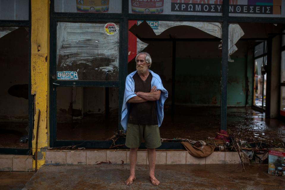 <p>A man stands in front of a damaged shop in the town of Mandra, northwest of Athens, on Nov. 15, 2017, after heavy overnight rainfall. (Photo: Angelos Tzortzinis/AFP/Getty Images) </p>