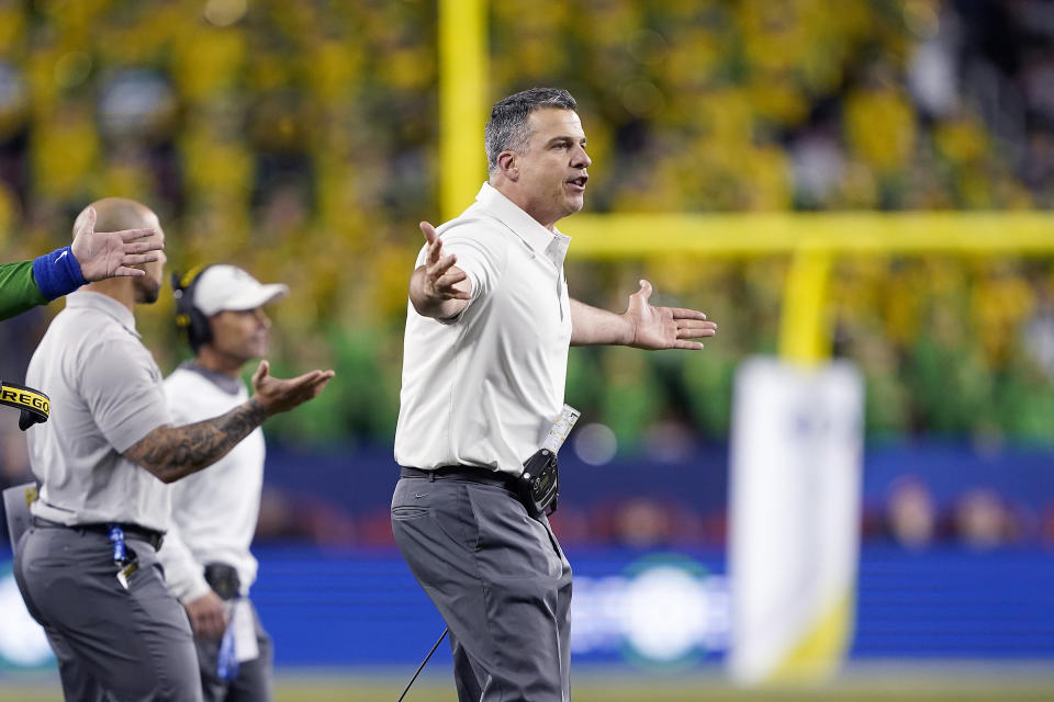 FILE - In this Dec. 6, 2019, file photo, Oregon head coach Mario Cristobal, right, gestures during the second half of the Pac-12 Conference championship NCAA college football game against Utah in Santa Clara, Calif. (AP Photo/Chris Pietsch, File)