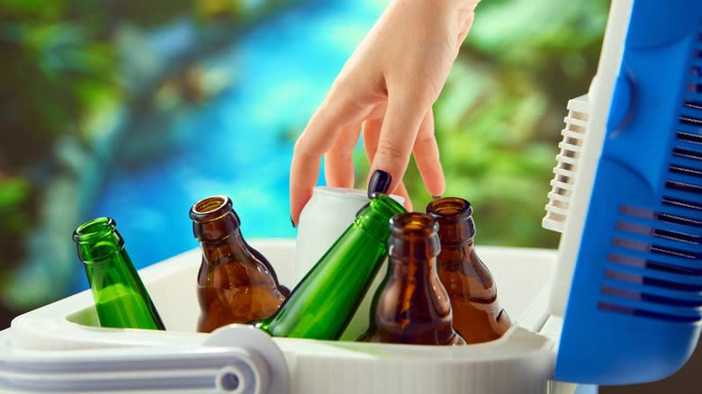 Hand reaching into a beer cooler