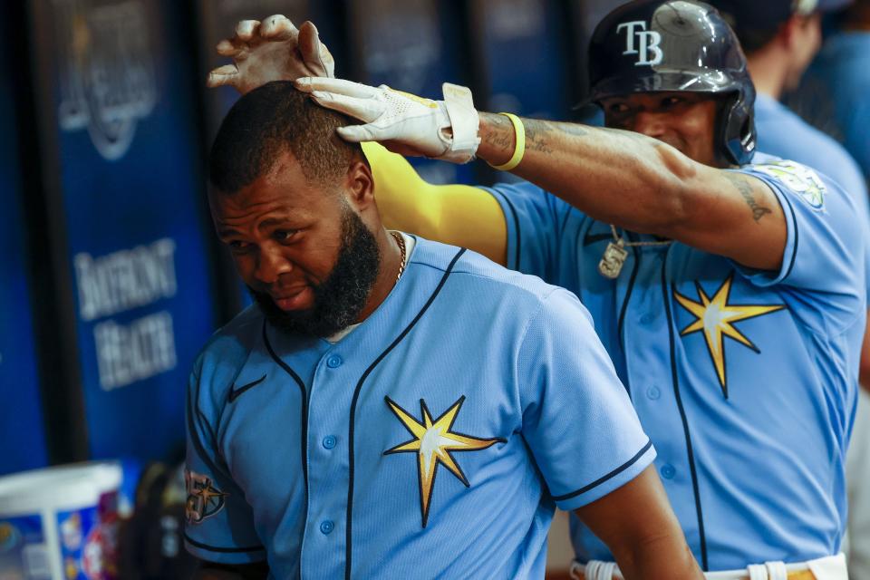 Tampa Bay Rays' Manuel Margot, left, celebrates with shortstop Wander Franco, right, after scoring against the Boston Red Sox in the fifth inning of a baseball game in St. Petersburg, Fla., Thursday, April 13, 2023. (Ivy Ceballo/Tampa Bay Times via AP)