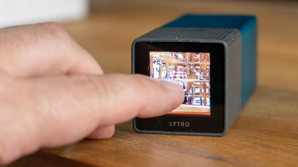  Tapping the touchscreen of the Lytro camera at the back to set the focus 