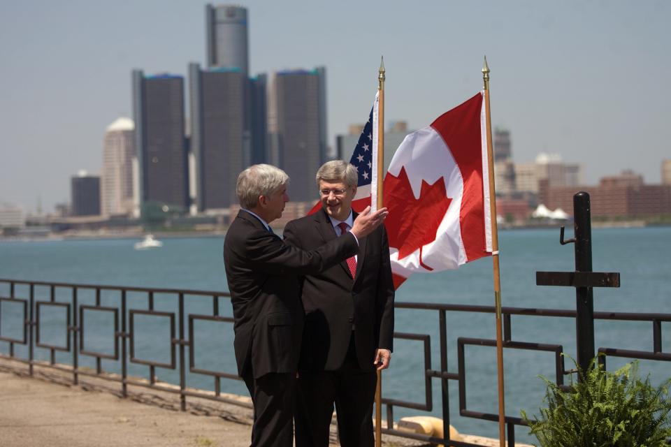 Prime Minister Stephen Harper right, and Michigan Governor Rick Snyder chat on the banks of the Detroit River in Windsor, Ontario, Canada, on Friday, June 15, 2012, ahead of an announcement for a new $1-billion bridge connecting the city with Detroit. (AP Photo/The Canadian Press,Mark Spowart )