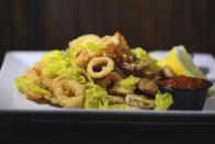 <p>Fried calamari (and maybe some beers) became the most popular appetizer in 1996, so much so where the term was used in <a href="https://www.nytimes.com/2014/08/12/upshot/special-sauce-for-measuring-food-trends-the-fried-calamari-index.html" rel="nofollow noopener" target="_blank" data-ylk="slk:56 New York Times articles;elm:context_link;itc:0;sec:content-canvas" class="link ">56 <em>New York Times </em>articles</a>.</p>