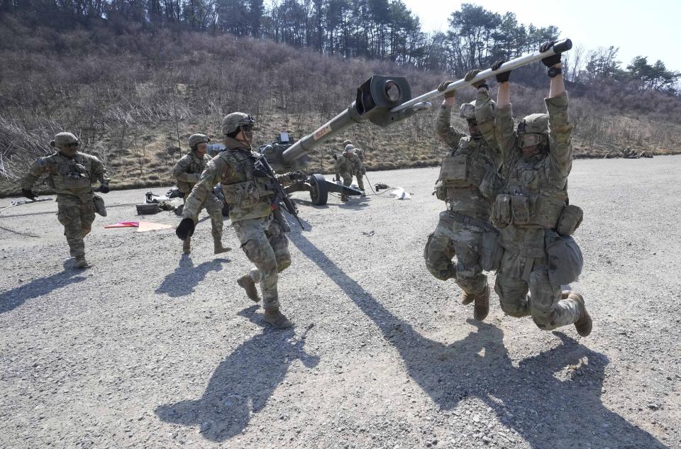 U.S. Army soldiers work on a M777 howitzer during a joint military drill between South Korea and the United States at Rodriguez Live Fire Complex in Pocheon, South Korea, Sunday, March 19, 2023. North Korea launched a short-range ballistic missile toward the sea on Sunday, its neighbors said, ramping up testing activities in response to U.S.-South Korean military drills that it views as an invasion rehearsal. (AP Photo/Ahn Young-joon)