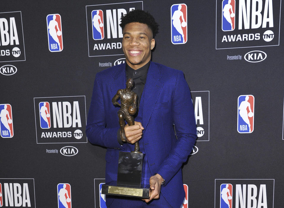 NBA player Giannis Antetokounmpo, of the Milwaukee Bucks, poses in the press room with most valuable player award at the NBA Awards on Monday, June 24, 2019, at the Barker Hangar in Santa Monica, Calif. (Photo by Richard Shotwell/Invision/AP)