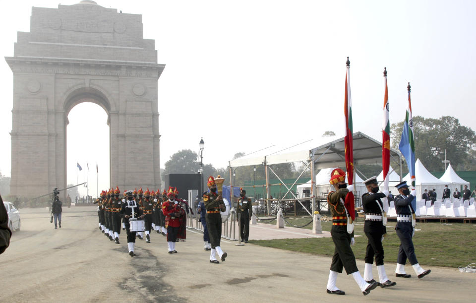 This handout photograph provided by the Indian Army shows soldiers carry a torch lit from the eternal flame in a ceremonious march to the war memorial, less than half a kilometer away, in New Delhi, India, Friday, Jan. 21, 2022. Indian Prime Minister Narendra Modi’s government came under fire from the opposition on Friday for shifting "an eternal flame” honoring Indian soldiers killed in the 1971 war with Pakistan to a new National War Memorial he inaugurated nearly three years ago. Rahul Gandhi, a top Congress party leader, accused the government of “removing history” by extinguishing the flame at the India Gate. The flame was lit by his grandmother and then Prime Minister Indira Gandhi in 1972. (Indian Army via AP)