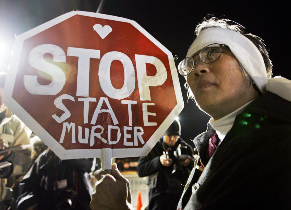 FILE - In this Dec. 12, 2005, file photo, Barbara Chan protests the execution of Stanley "Tookie" Williams, the founder of the Crips gang, outside of San Quentin State Prison in San Quentin, Calif. Williams was executed early Dec. 13. California voters face opposite choices to fix the state's broken death penalty. They can repeal capital punishment in November or reform it so convicted murderers are actually executed. (AP Photo/Eric Risberg, File)