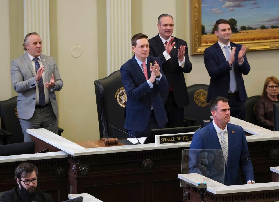 Senate Pro Tempore Greg Treat, Lt. Gov. Matt Pinnell, House Speaker Charles McCall and Rep. Kyle Hilbert stand and clap after a statement by Gov. Kevin Stitt during the start of the 2023 legislative session.