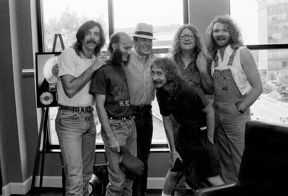 Country music legend Don Gibson, in hat, poses with members of the Kentucky Headhunters, who scored a recent country-rock hit with the Gibson classic "Oh Lonesome Me" during an Opryland Music Group luncheon honoring Gibson, a 1990 Country Music Hall of Fame nominee, on Aug. 16, 1990. Band members are Ricky Phelps, left, Fred Young, Greg Martin, Richard Young and Doug Phelps.