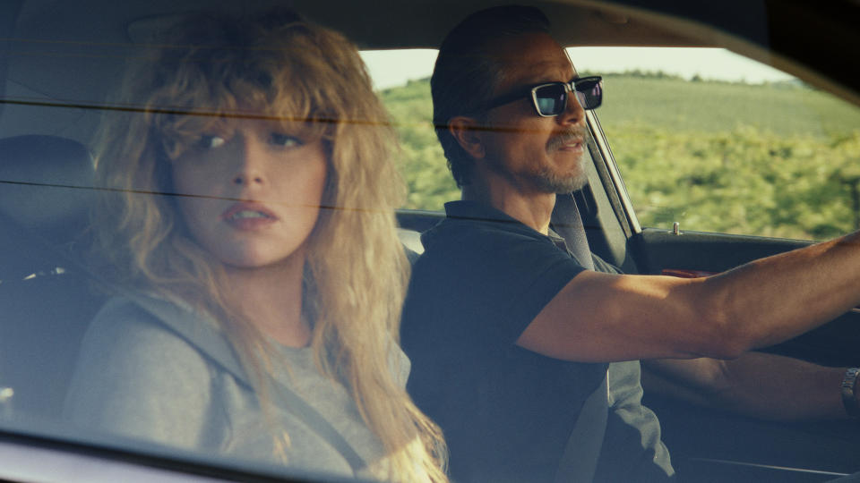 Charlie Cale looks concerned as she looks out of a car's passenger-side window in Peacock's Poker Face