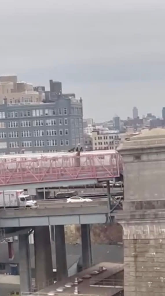 Video shows seven reckless subway surfers riding on top of a train headed toward Manhattan. NO CREDIT